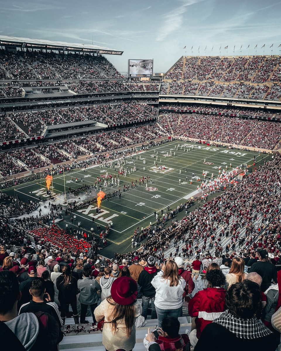 How do NFL clubs make money? people watching soccer game during daytime