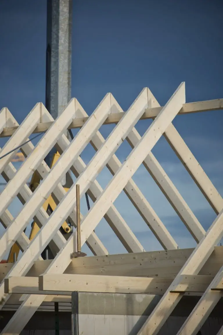 How do home builders make money? white wooden fence under blue sky during daytime